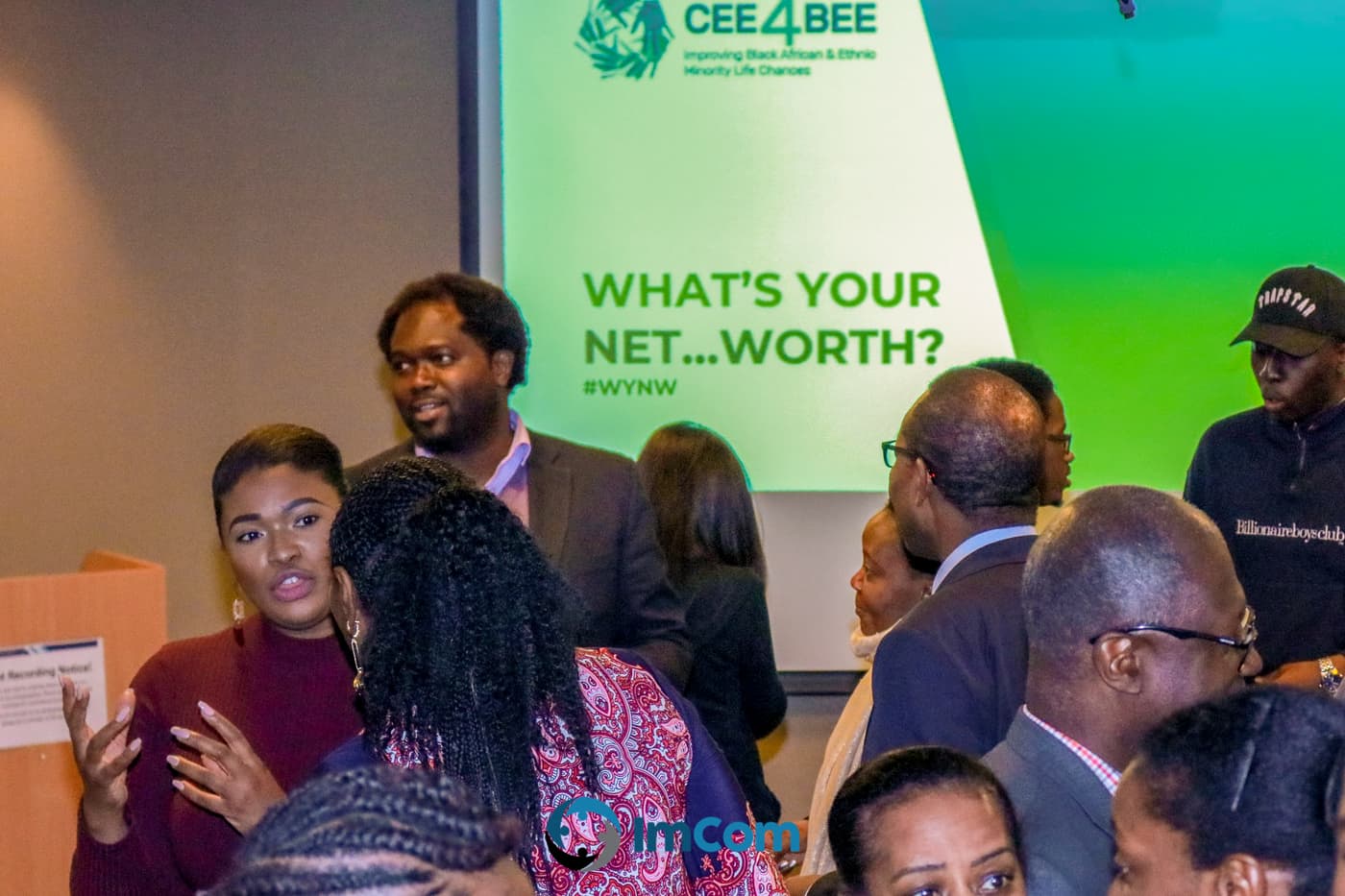 Attendees in front of the What's Your Net Worth slide