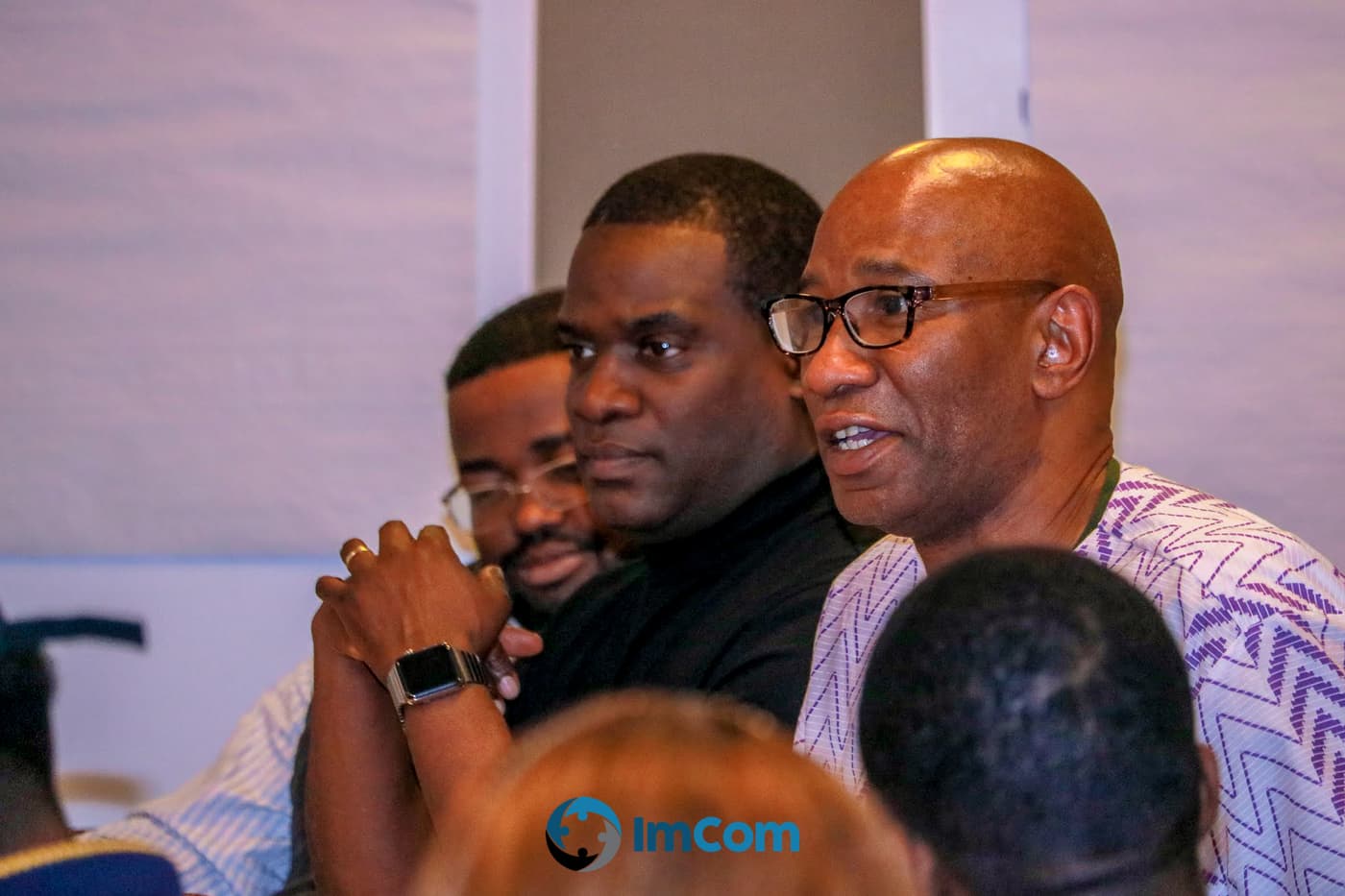 Two attendees listening from the audience
