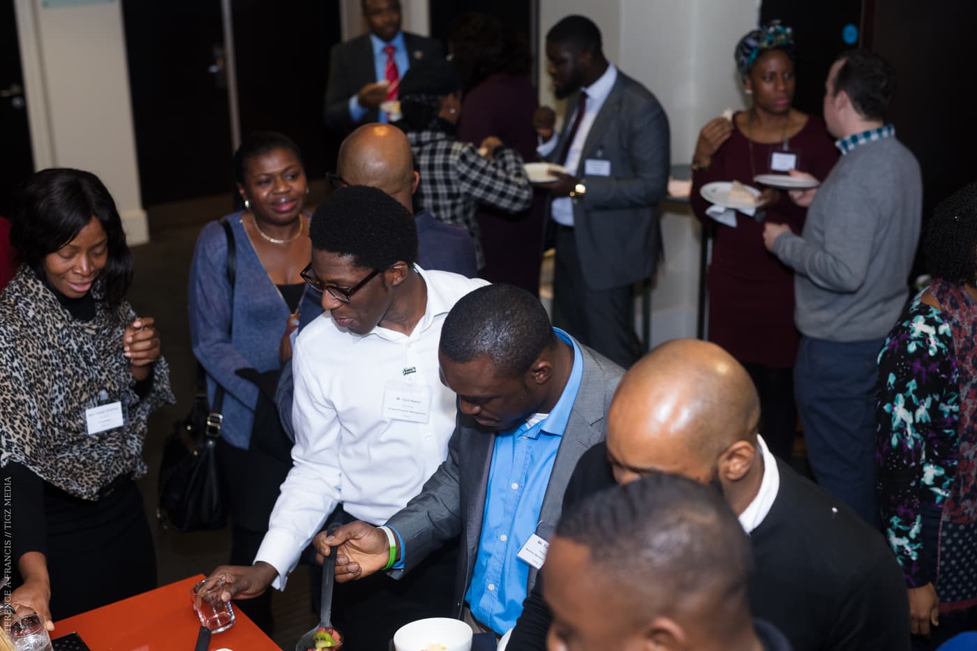 Attendees gathered closely in conversation