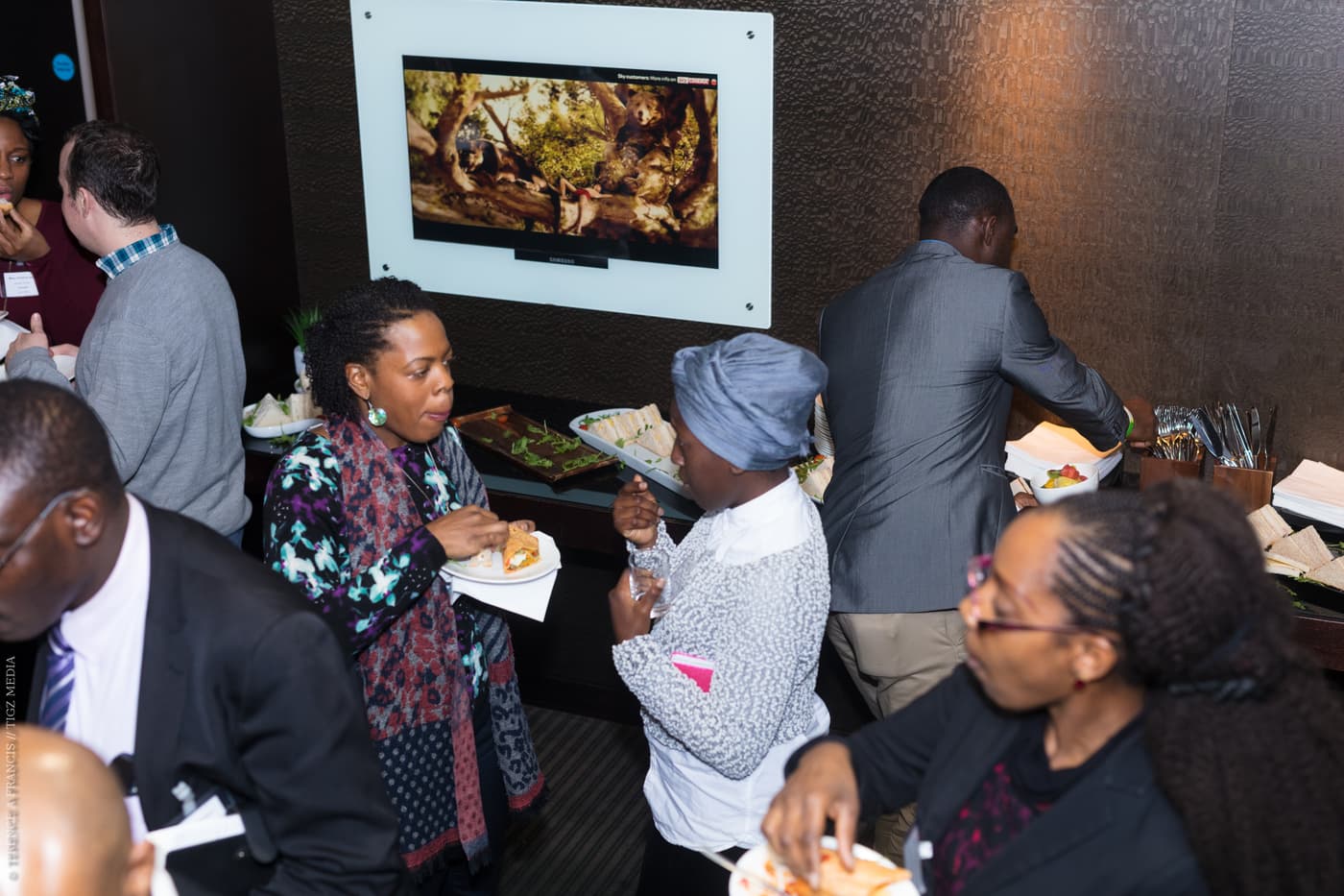 Attendees helping themselves at the refreshments table