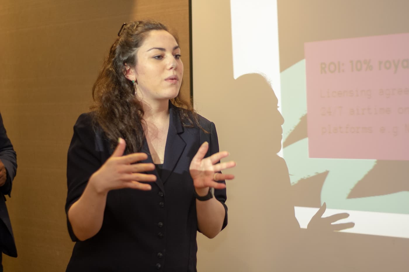 A speaker explaining a point to the room