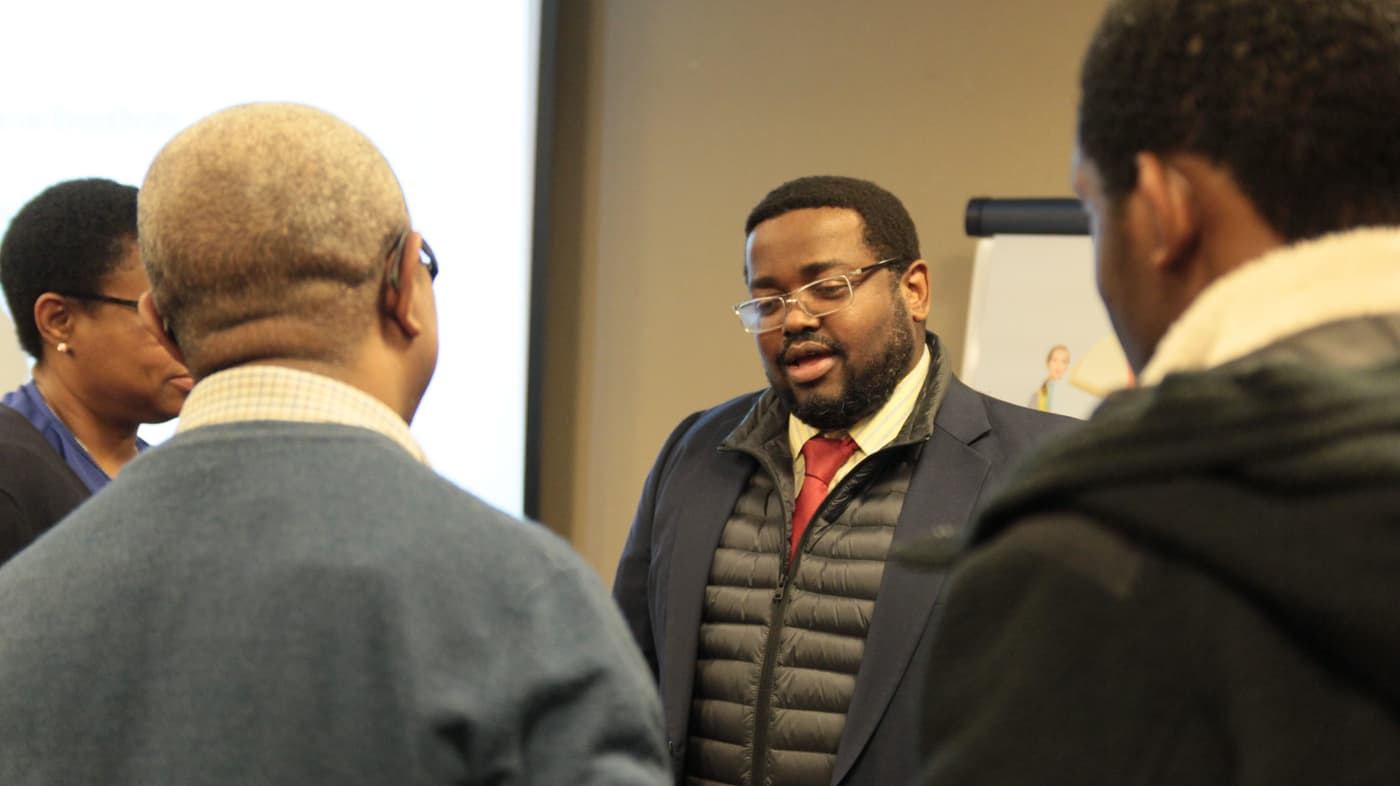 A speaker in conversation with a guest