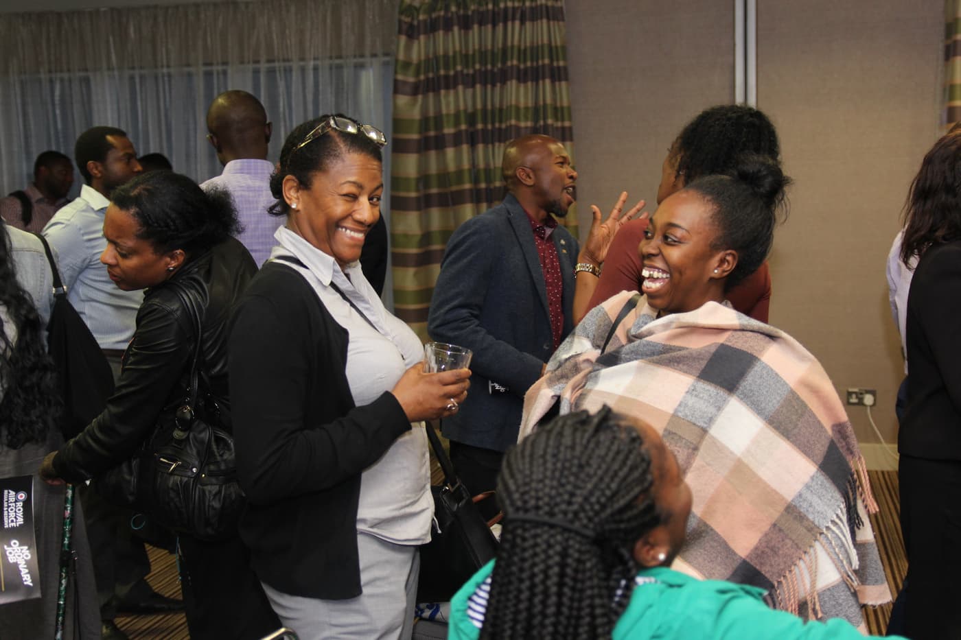 Attendees laughing together during the networking hour